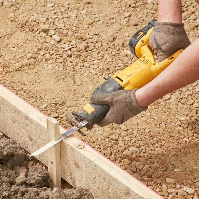 Chopping the top of form stakes off for easier screeding | Construction Pro Tips