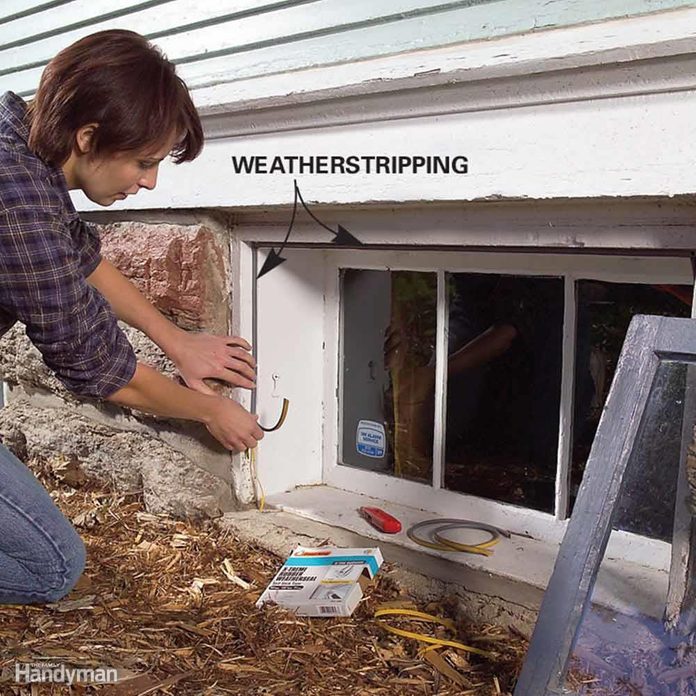 Woman adds weatherstripping to an egress window