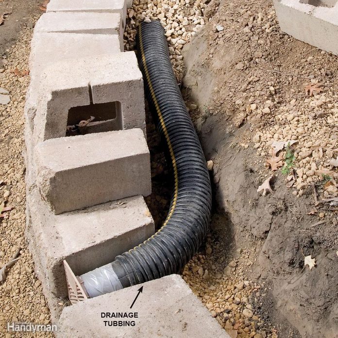 drainage pipe winds behind a retaining wall