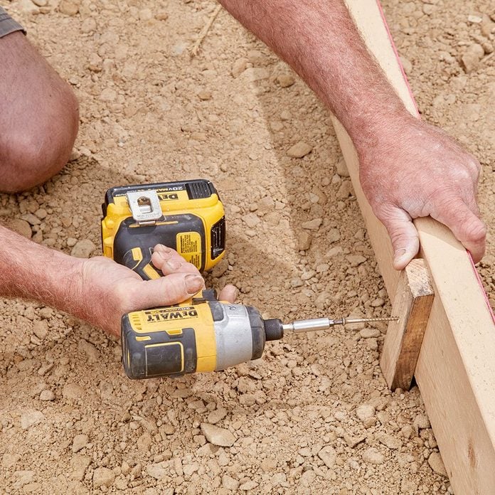 Screw form stakes into the form | Construction Pro Tips