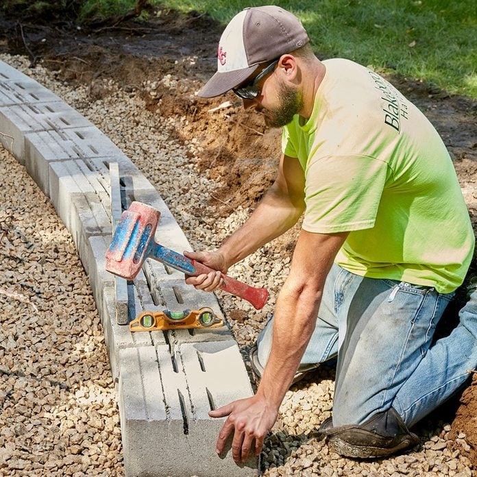 Creating a level block base for a stone retaining wall | Construction Pro Tips