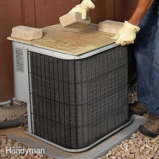 Covering Air Conditioner Condenser in Winter With Plywood