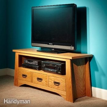 A TV sits on an elegant wooden TV stand
