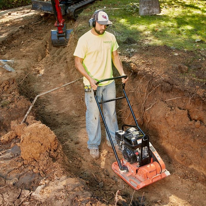 Compacting the dirt in the bottom of a trench | Construction Pro Tips