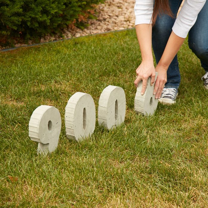 concrete house numbers placing in ground backyard wedding decorations