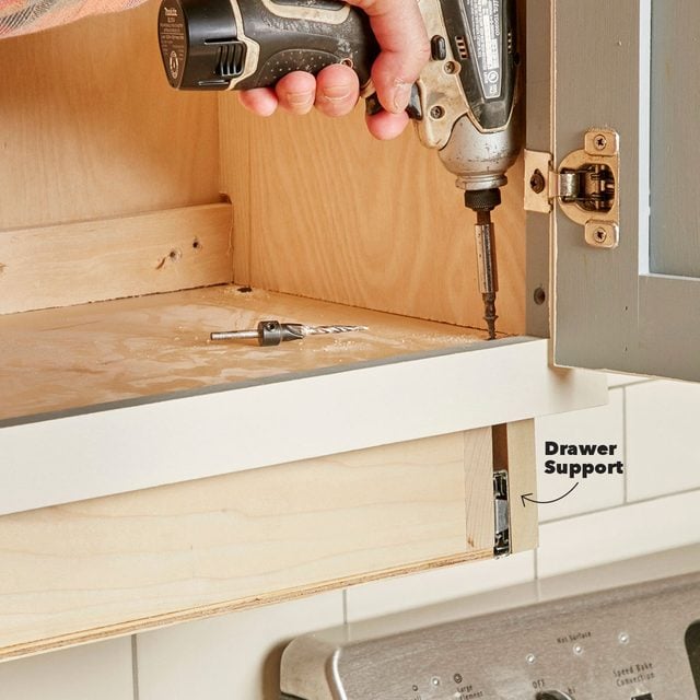 screw under-cabinet drawer in place