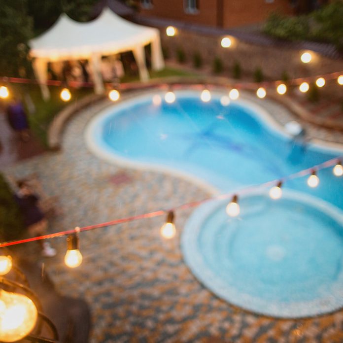 pool with outdoor string lights