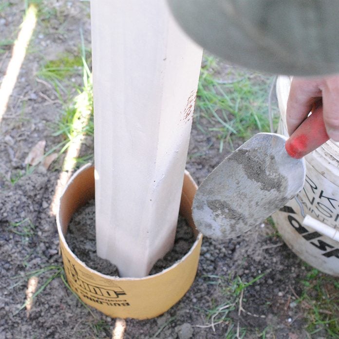 Fill tube with cement and insert post birdhouse pole