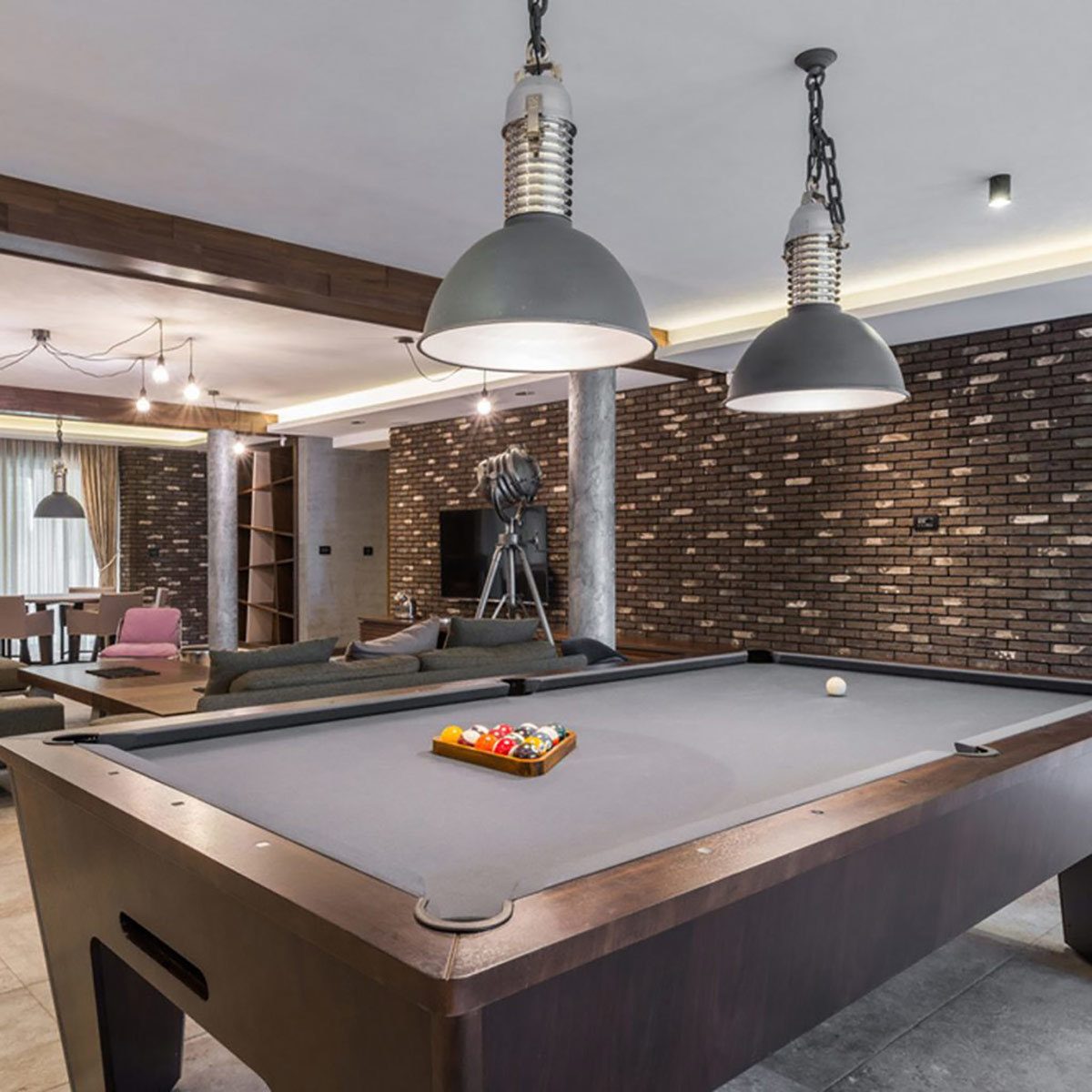 dfh17aug016_shutterstock_360392798-game room pool table with stone brick veneers