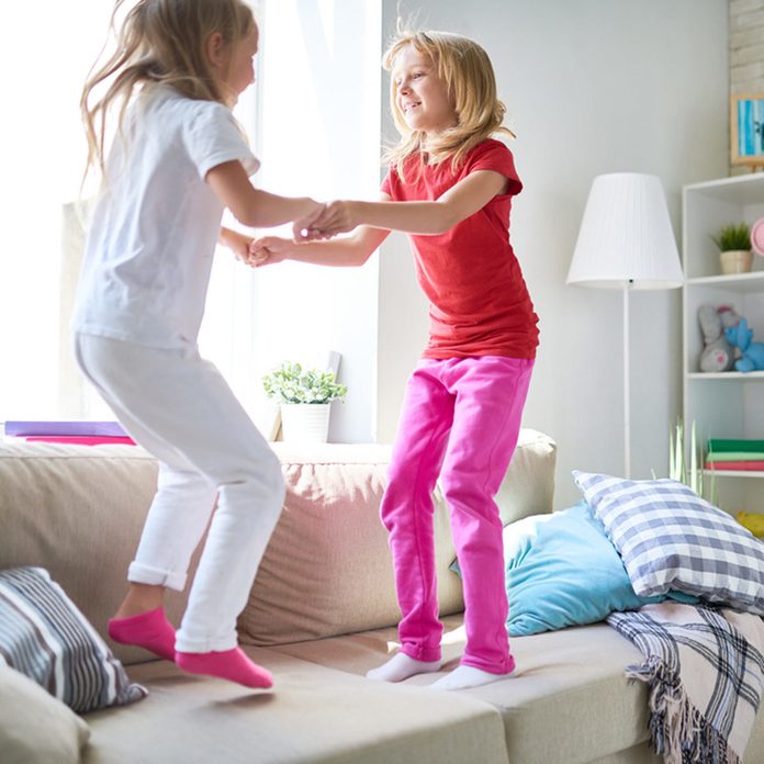 shutterstock_695124241-1200x1200 little girls jumping on couch furniture