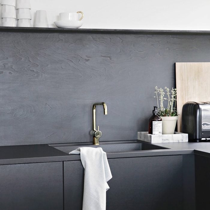 modern stone kitchen backsplash with dark cabinets