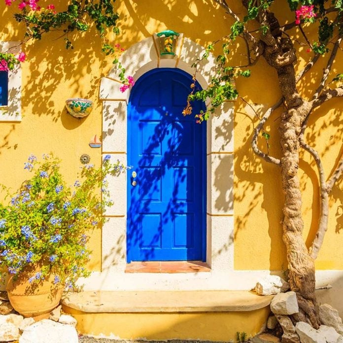 blue door yellow stucco siding Mediterranean home exterior home colors, house exterior colors