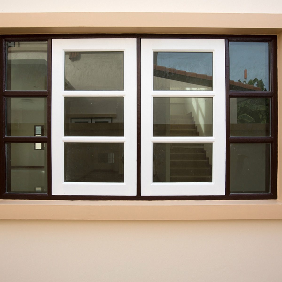 peaches and cream exterior color window with black shutters