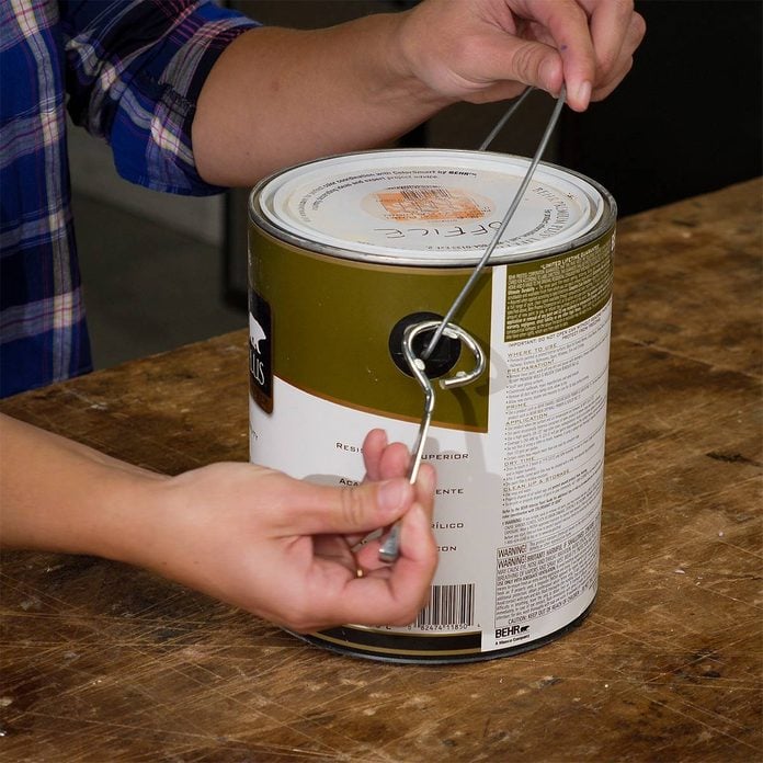 hooking paint can opener onto paint can handle