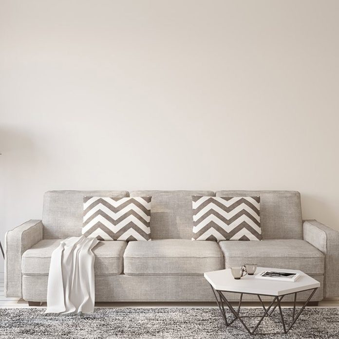 dfh17jul034_520261186_06 gray couch light color wall paint chevron pillows grey rug living room