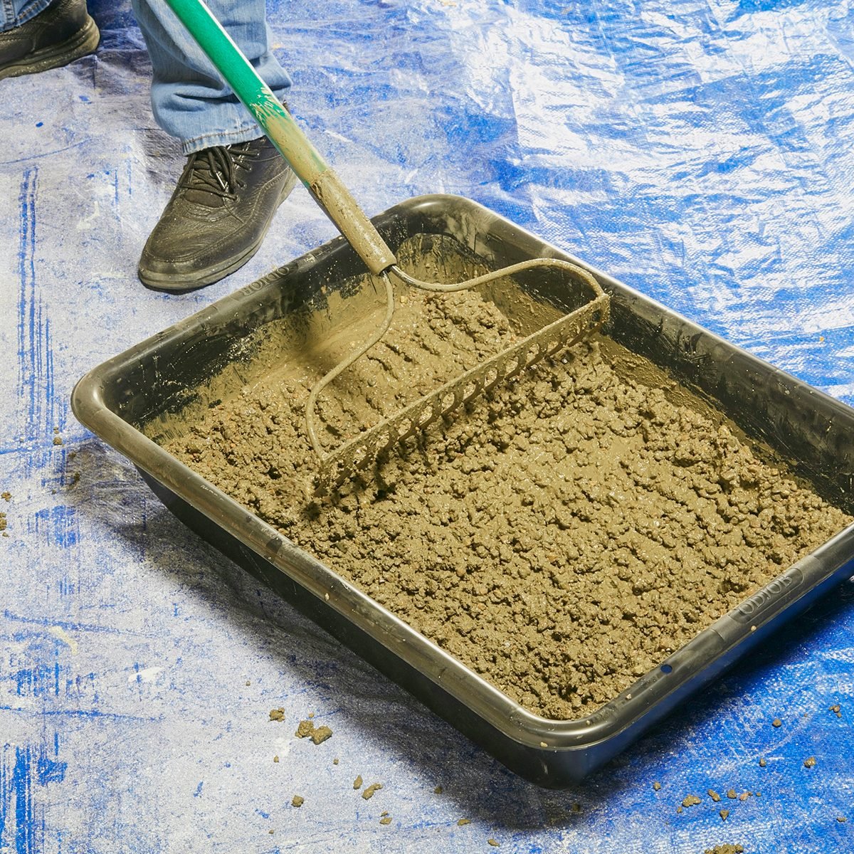 Mixing concrete in a tub with a rake | Construction Pro Tips