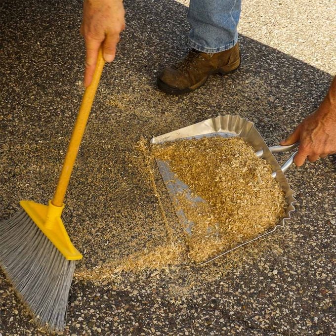sweeping up oil-soaked sawdust