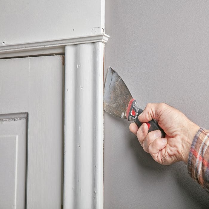 using a putty knife to separate the knife from the wall