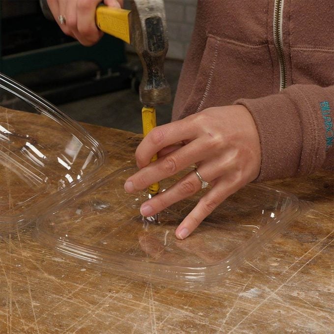 punching holes in plastic clamshell container from salad bar