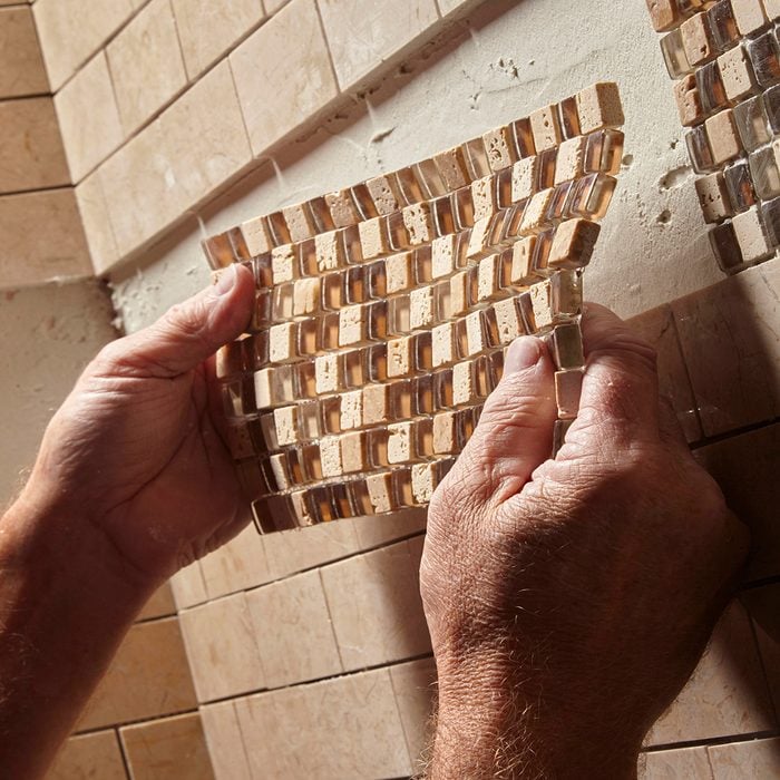 positioning a piece of mosaic tile | Construction Pro Tip