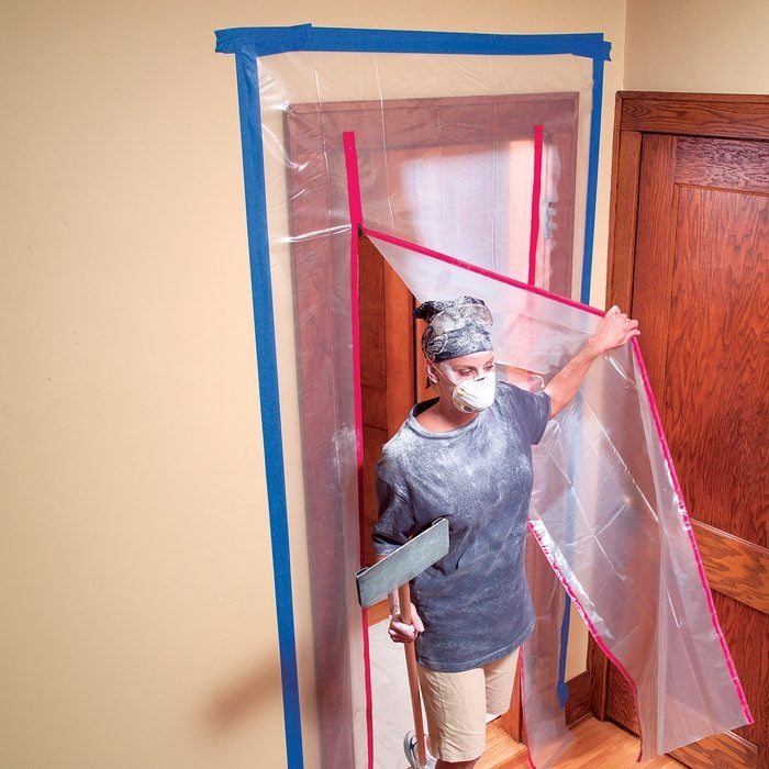 Room sealed off with poly sheets and tape | Construction Pro Tips