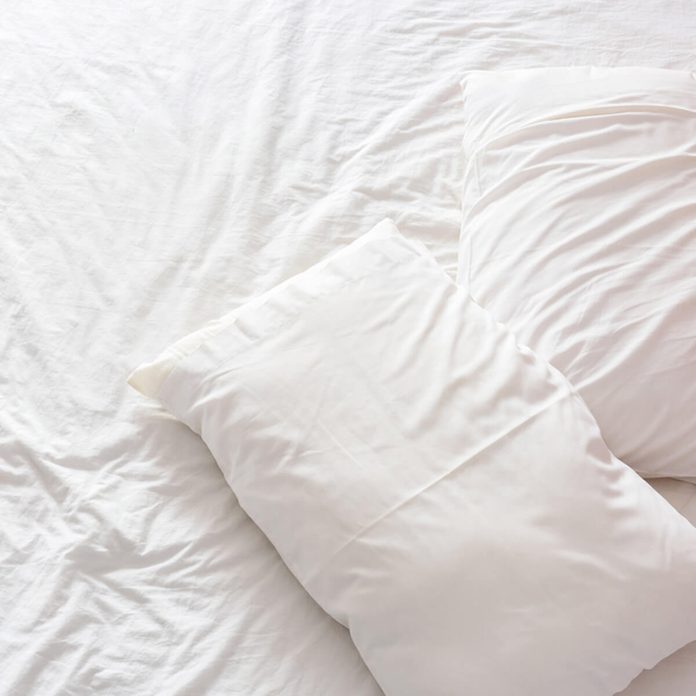 white bed sheets pillows