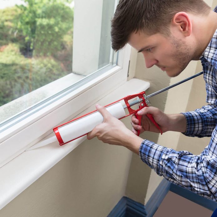 shutterstock_686328526 caulk a window to keep your home warm