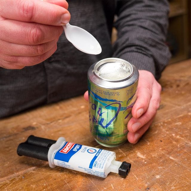 mixing epoxy on bottom of aluminum can
