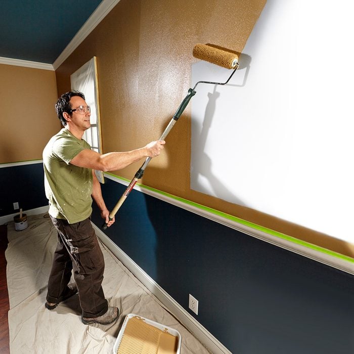 Professional painter rolling paint on to a wall | Construction Pro Tips