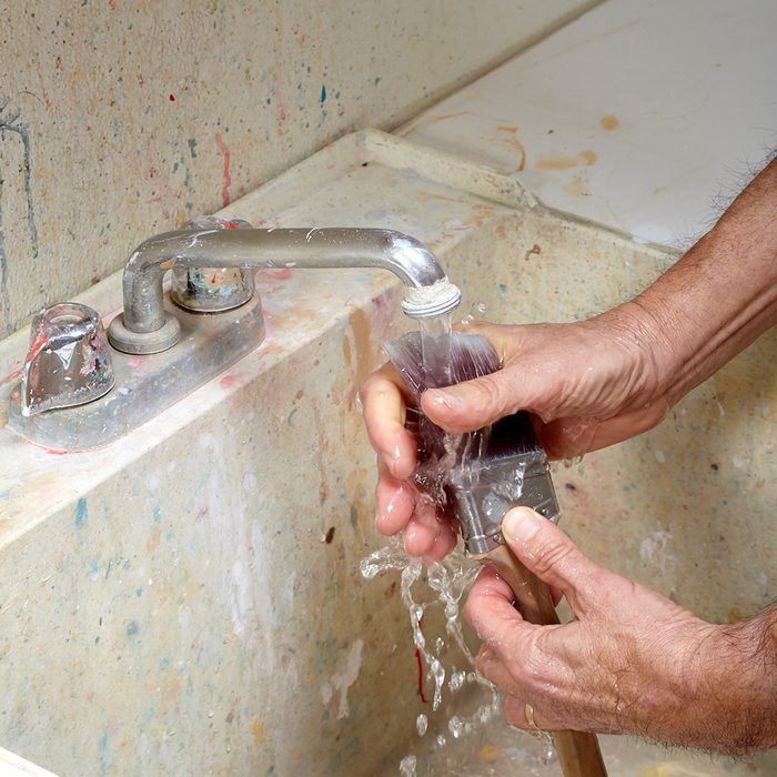 Running water down into the brushes of a paint brush | Construction Pro Tips