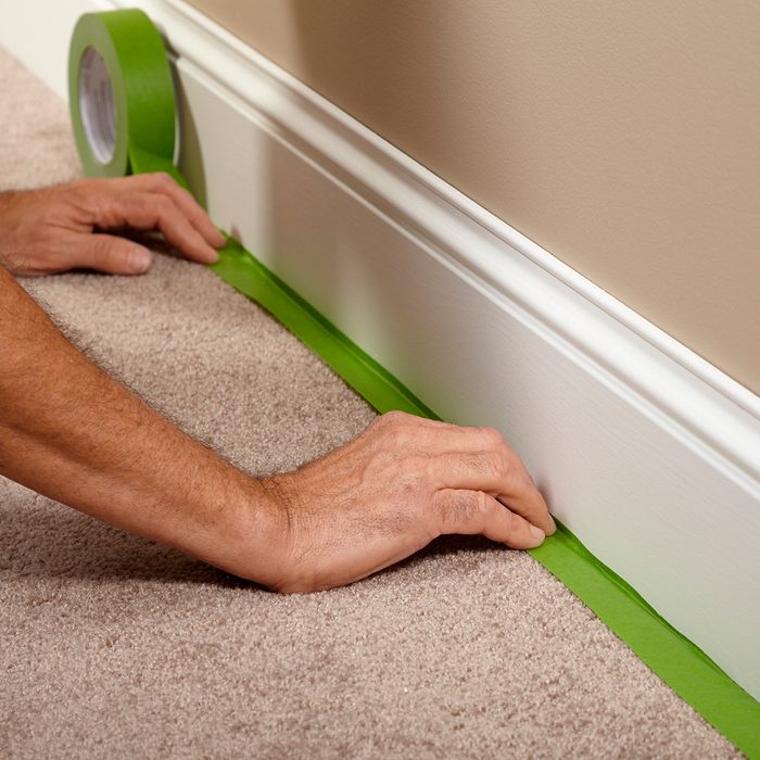 Taping off the carpet before painting | Construction Pro Tips