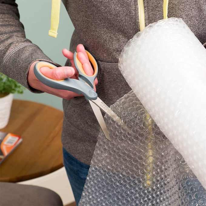 cutting a piece of bubble wrap
