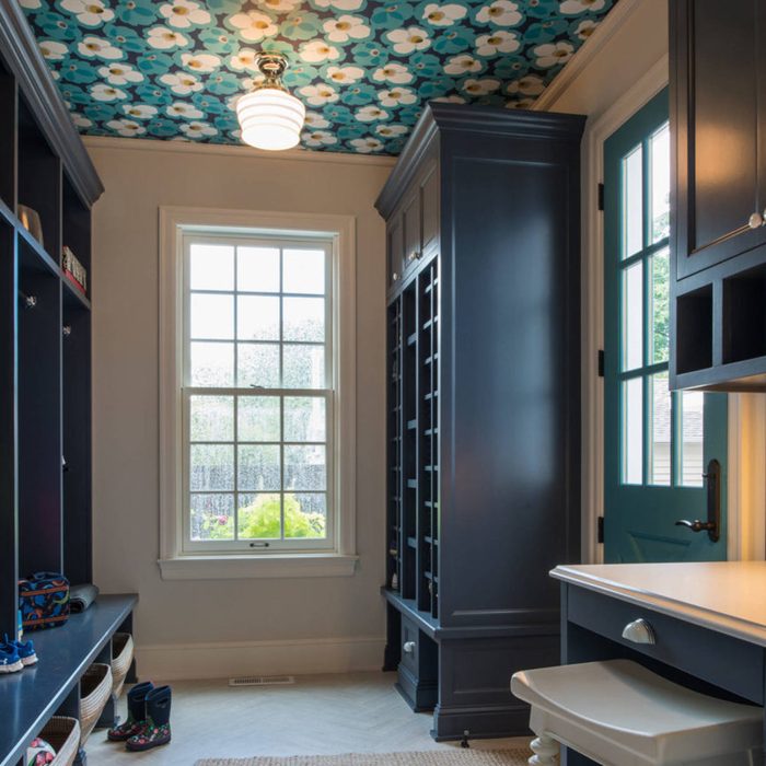 a mudroom with wallpaper on the ceiling