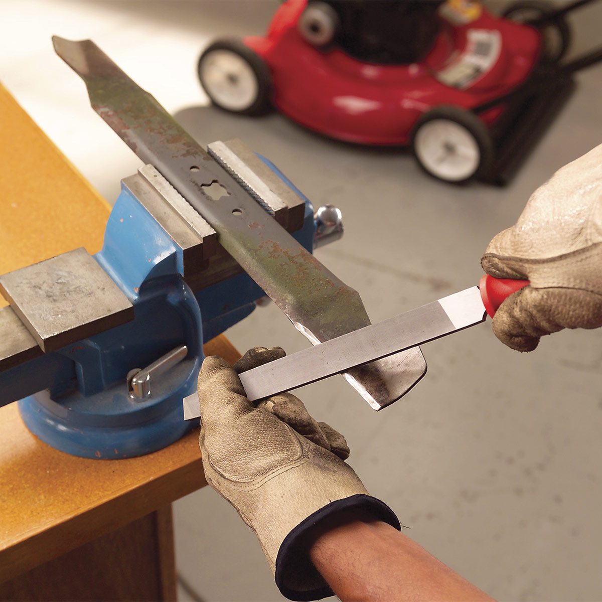 sharpening lawn mower blade with a file