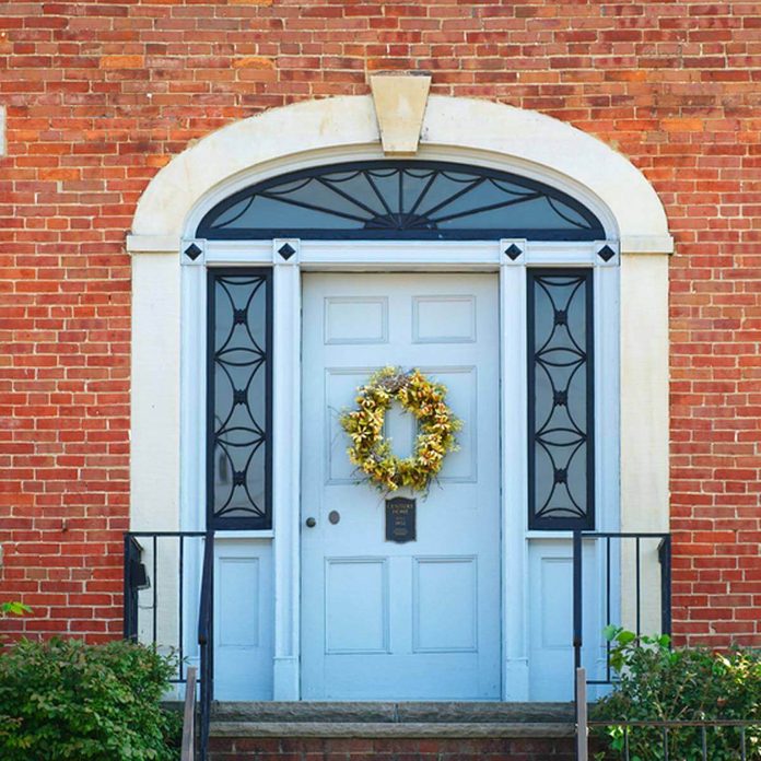 wreath on front door brick home