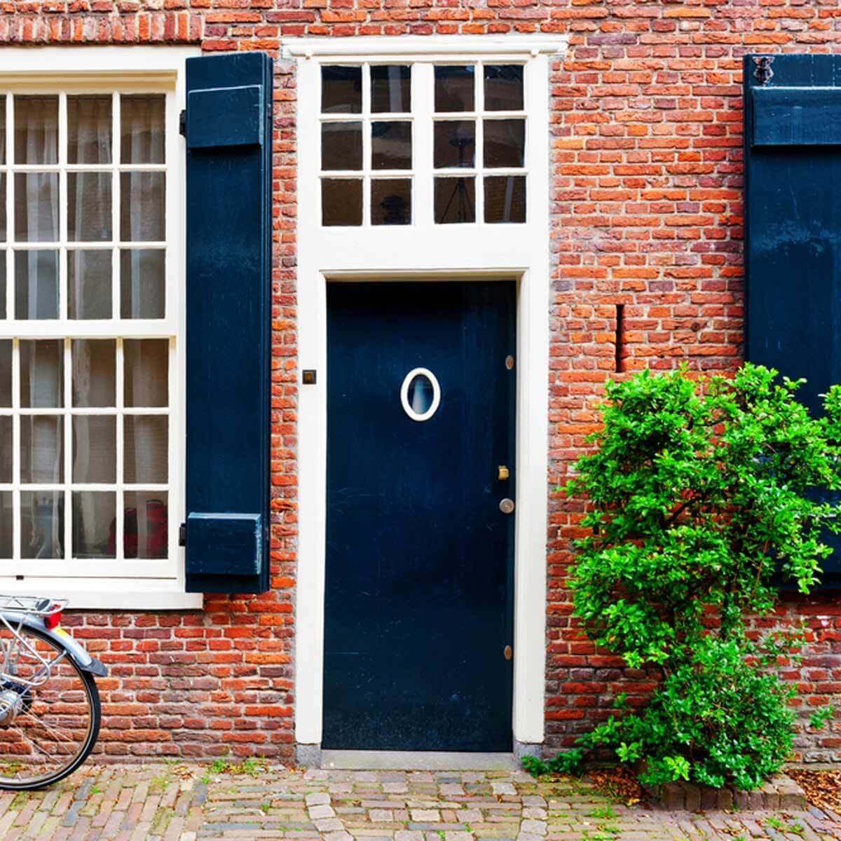 Dark Blue Front Door with Matching Shutters Brick siding