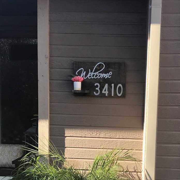 wood and metal house number sign