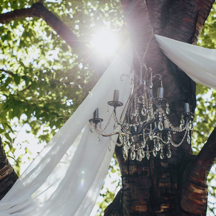outdoor wedding hanging chandelier from a tree