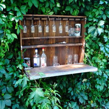 outdoor wooden bar with glasses