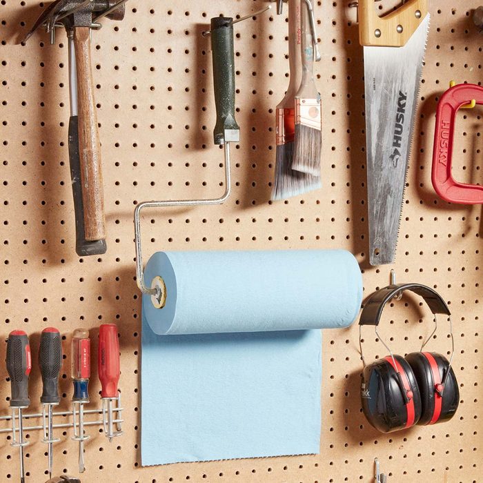 paint roller paper towel holder on peg board with other tools