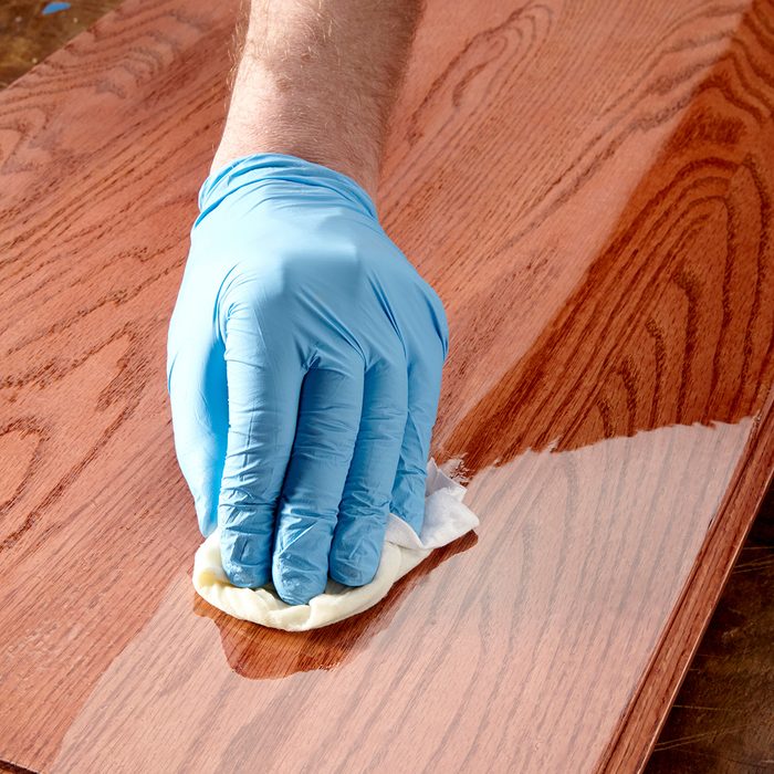 Wiping poly finish on wood with a rag | Construction Pro Tips
