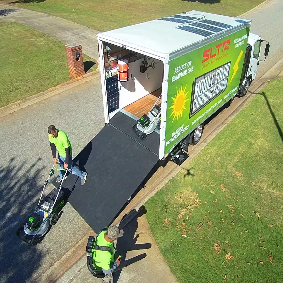 People removing landscaping equipment from Greenwork's solar truck | Construction Pro Tips