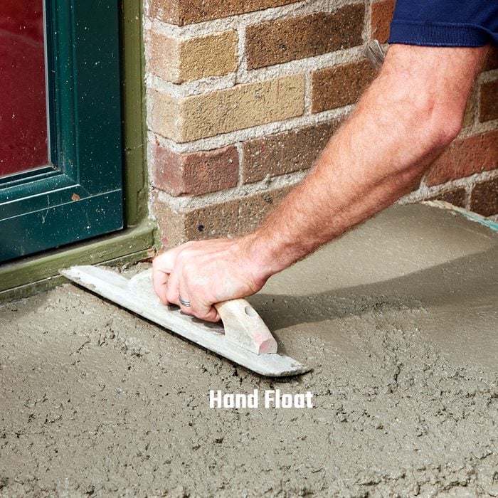 Smoothing concrete surface with hand float | Construction Pro Tips