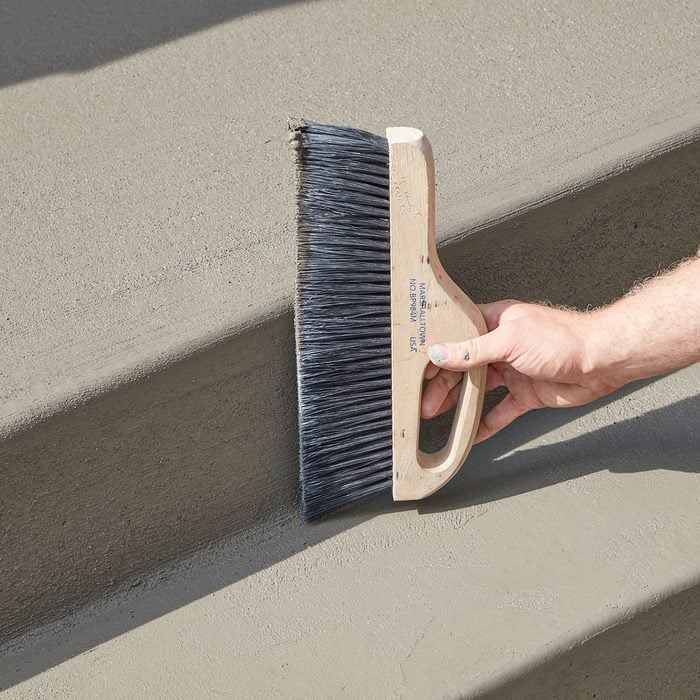 Brooming the edges of the step | Construction Pro Tips