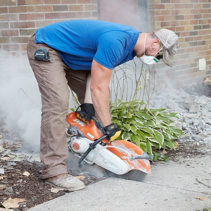 Slicing away from the sidewalk with a concrete saw | Construction Pro Tips