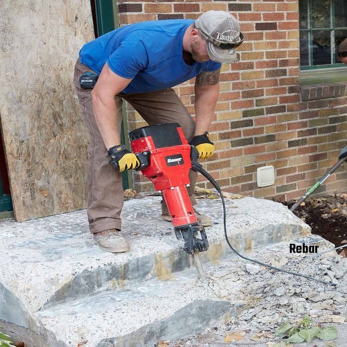 Breaking down an old step with a jackhammer | Construction Pro Tips
