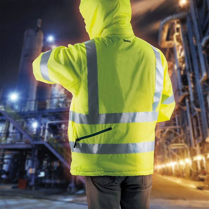 Worker wearing a heated and reflective jacket | Construction Pro Tips