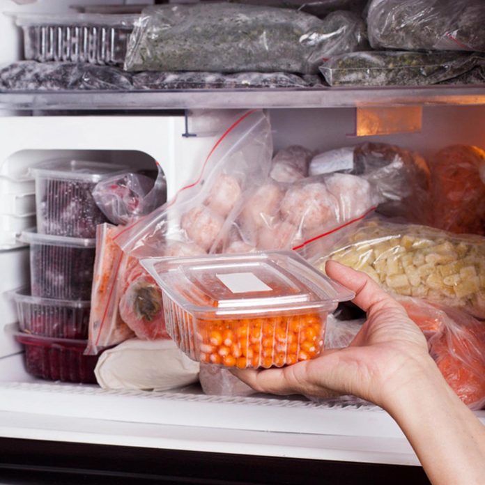 Frozen food in the refrigerator. Vegetables on the freezer shelves.; Shutterstock ID 1013189377