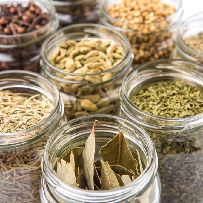 Cardamom, star anise, cinnamon, clove, coriander seed spices and dried bay leaves, parsley, thyme, rosemary herbs in mason jars over white background; Shutterstock ID 293429393; Job (TFH, TOH, RD, BNB, CWM, CM): Taste of Home