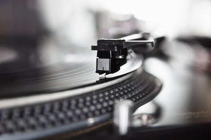 Dj turntable player playing vinyl record disc with hip hop music.Closeup,focus on needle cartridge headshell.Disc jockey audio equipment for scratch.Hifi sound system